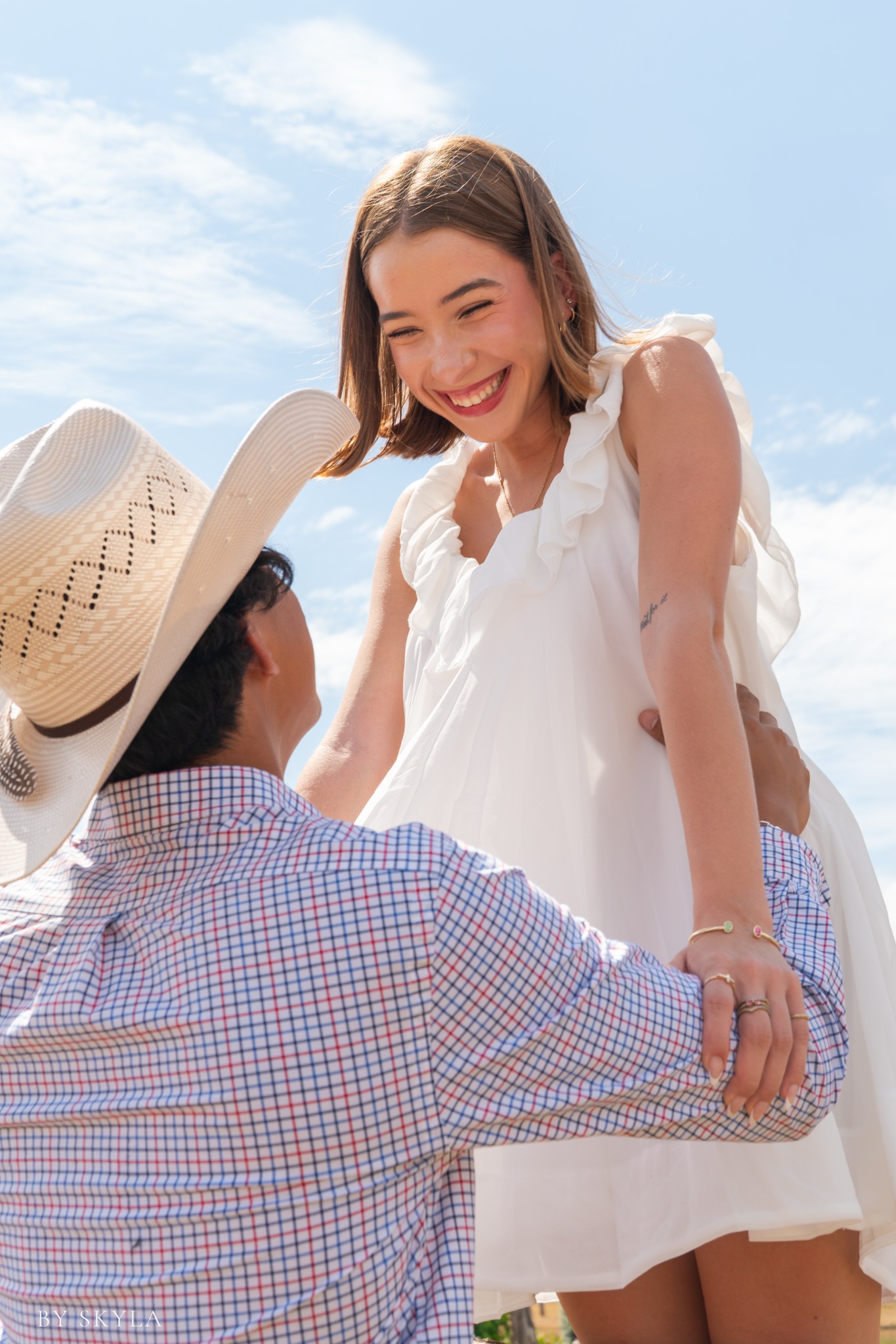 Couple portrait photographed outdoors under a bright Texas sky