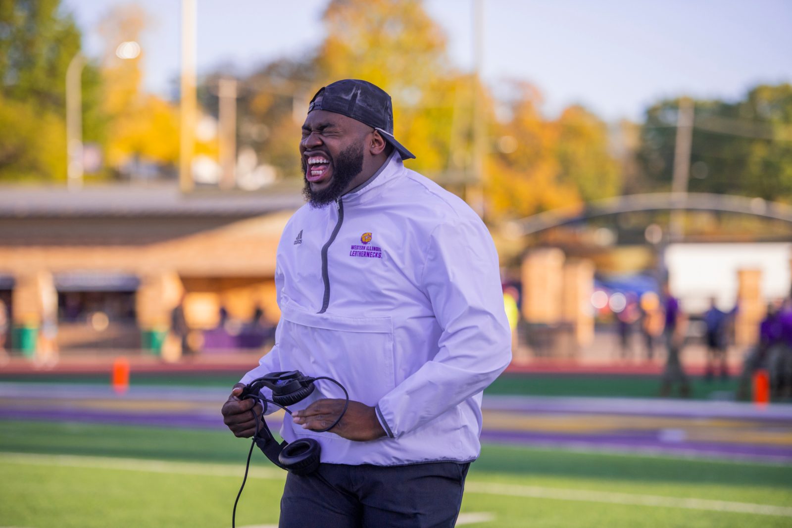 Working the sideline with a camera at a college football game