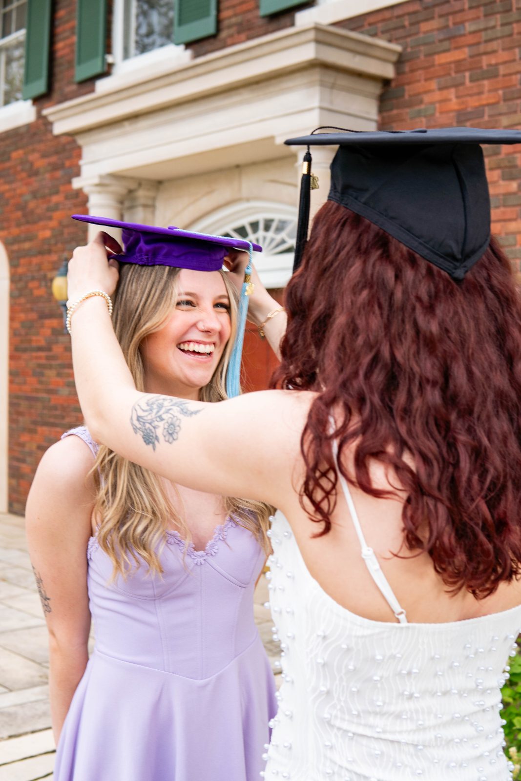 Two graduates embracing