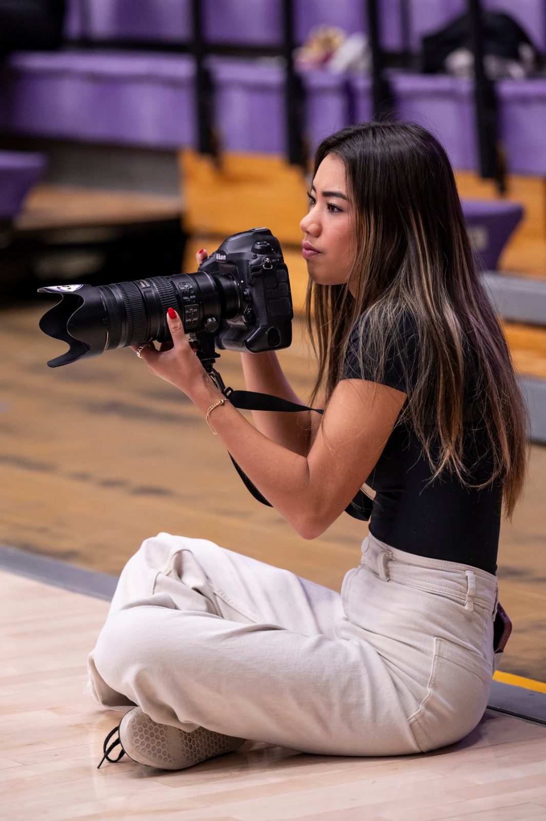 Mia photographing courtside with her camera