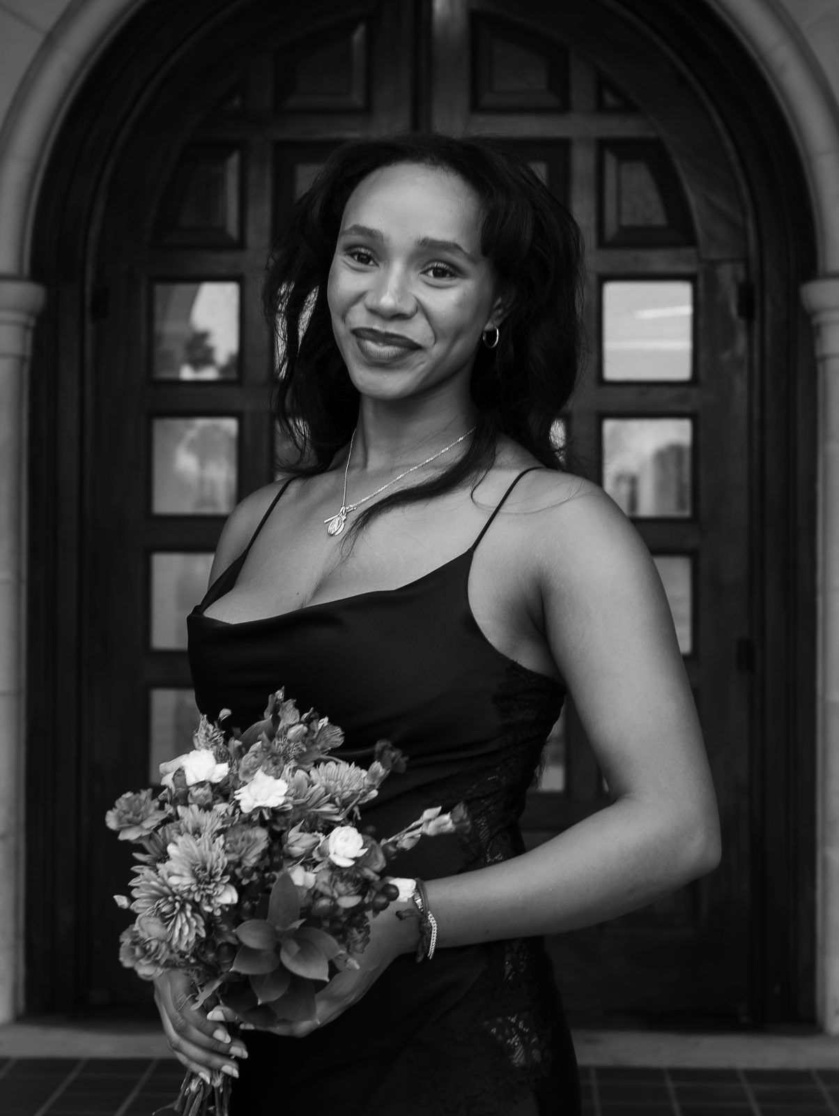 Black and white portrait of a woman holding flowers