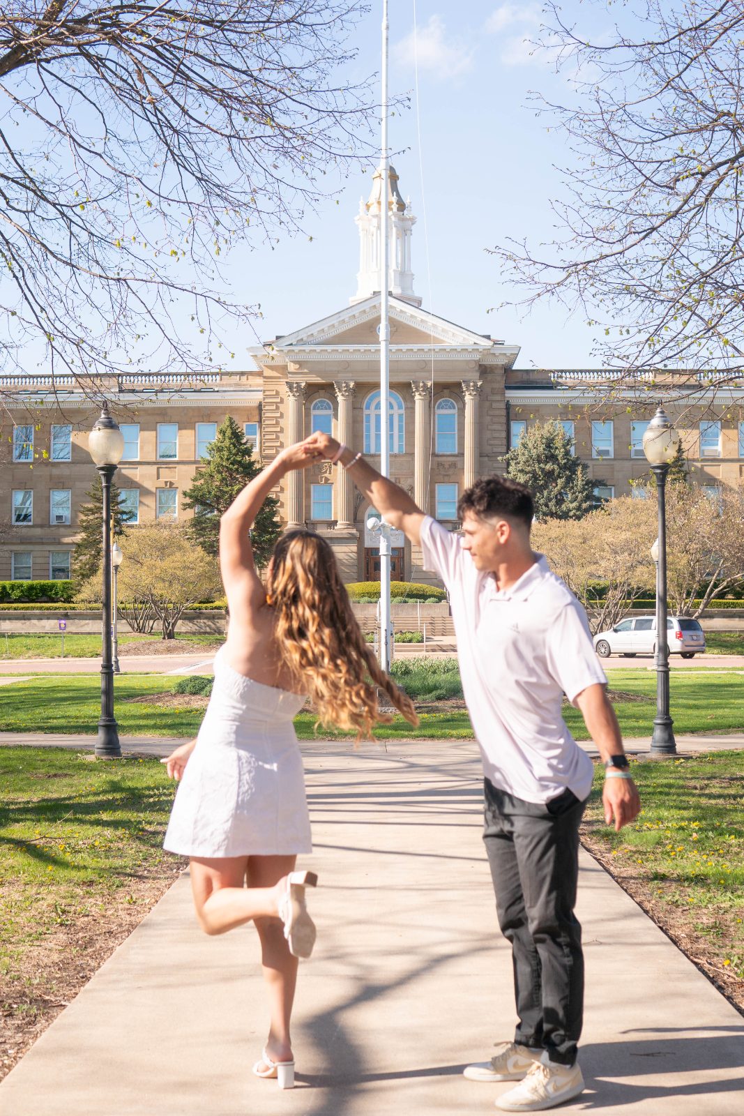 Couple dancing on a campus path