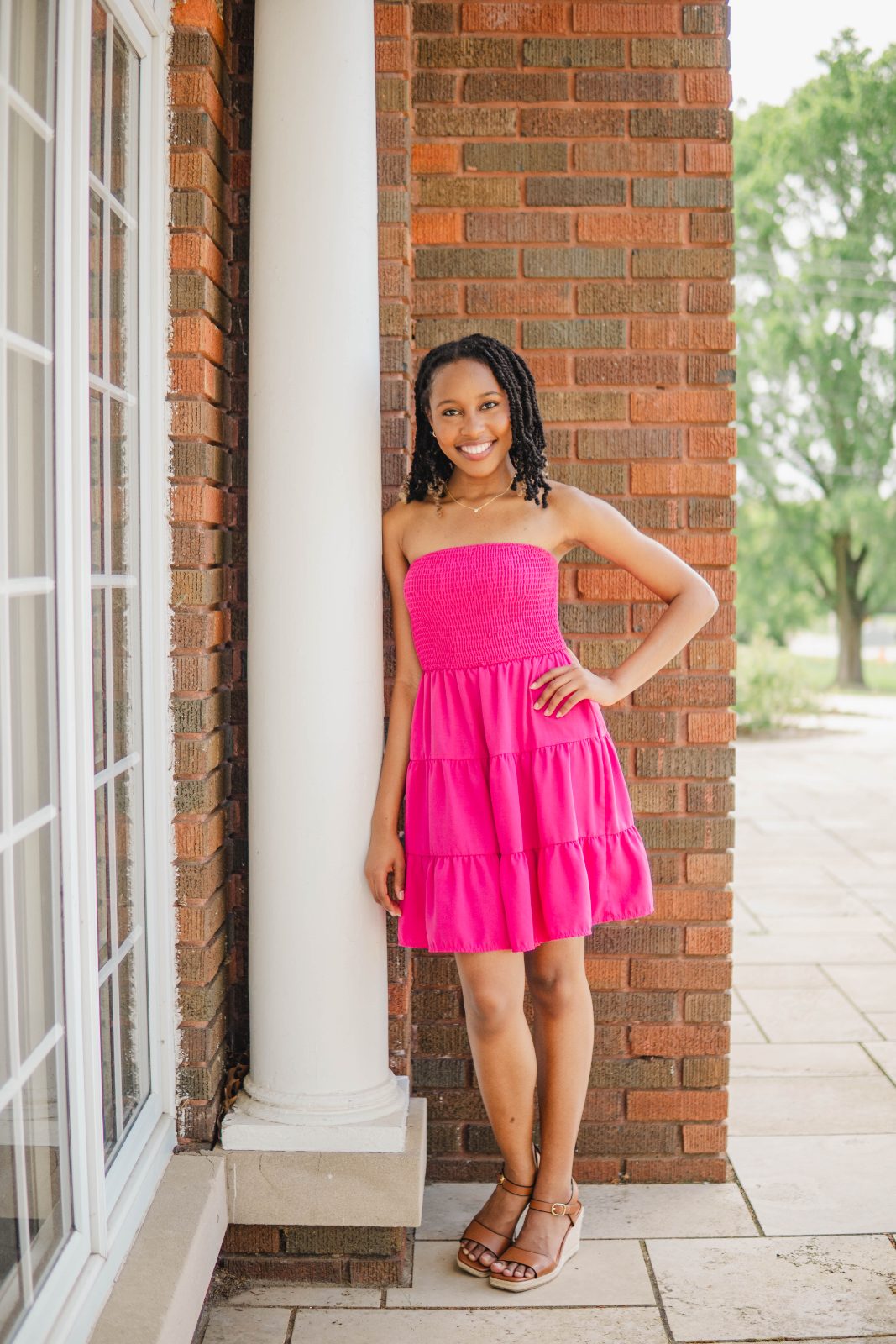 Full-length portrait beside brick columns, Kingsville