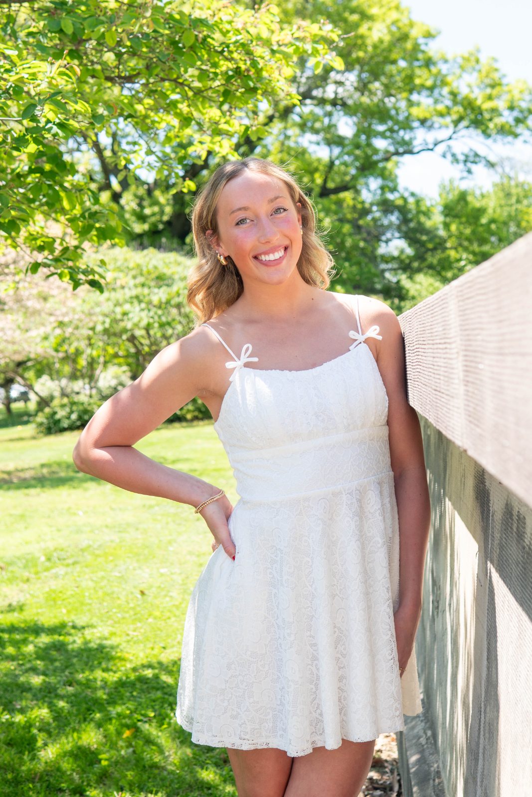 Woman in a white dress standing in a garden