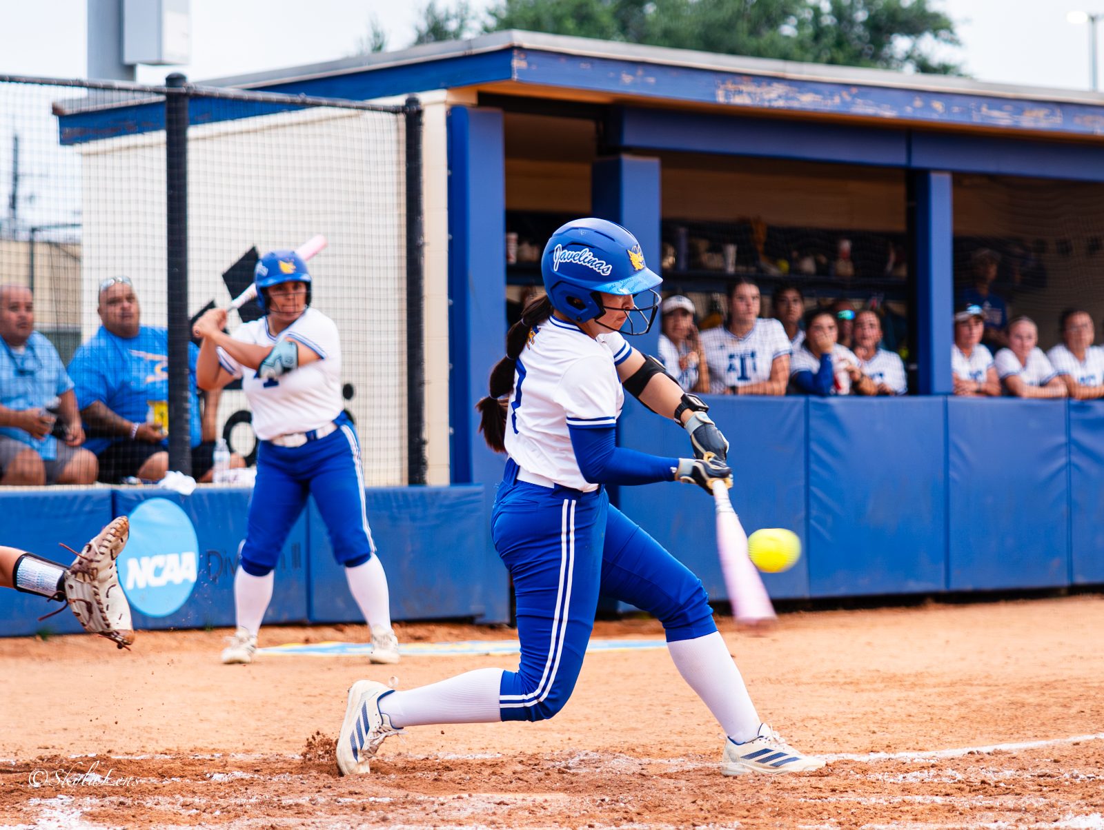 Softball batter connecting with a pitch